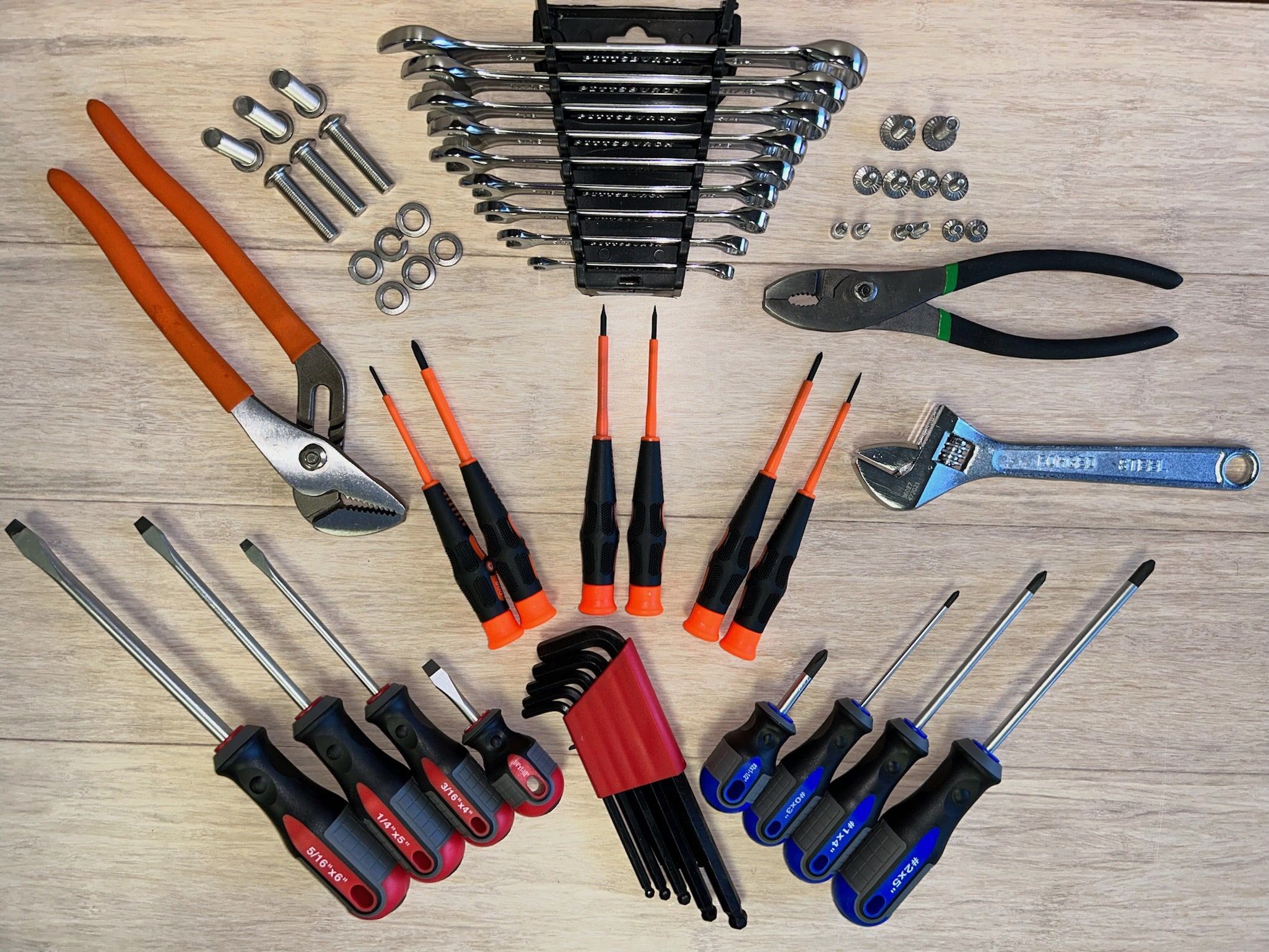 Various non powered hand tools displayed on a wood background for the Service Tool Kit for Juiced Rite Juicers